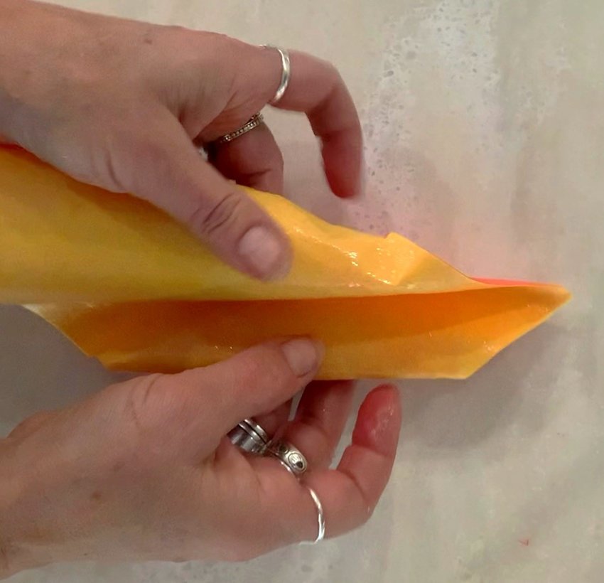 Roll in the edges and fold your petal into shape. Place it on foil to dry. Repeat process to make more petals...